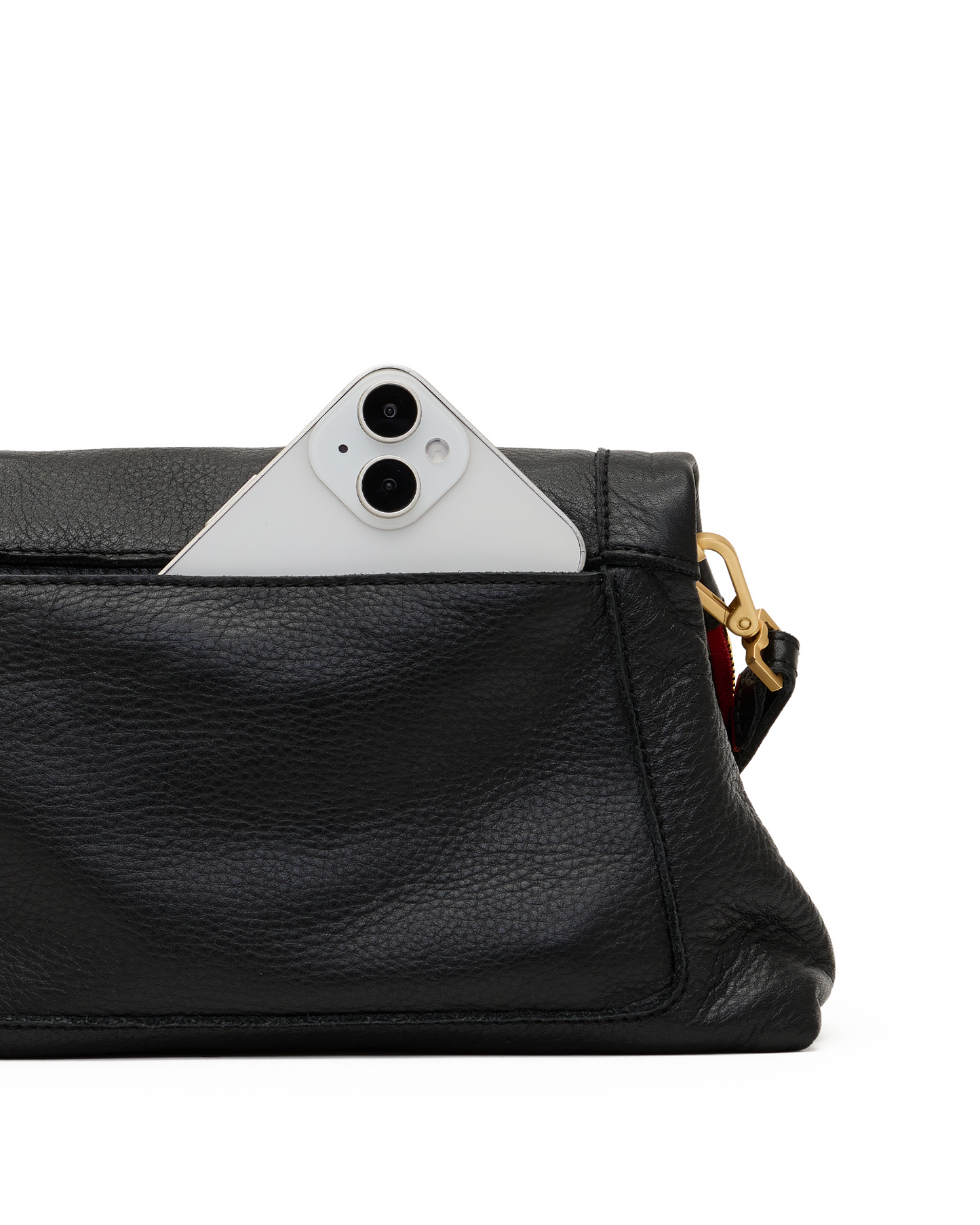 Close-up of a black pebbled leather clutch or crossbody bag with a white smartphone partially tucked into the top pocket, showing a gold-tone hardware detail and a hint of red lining on a white background.