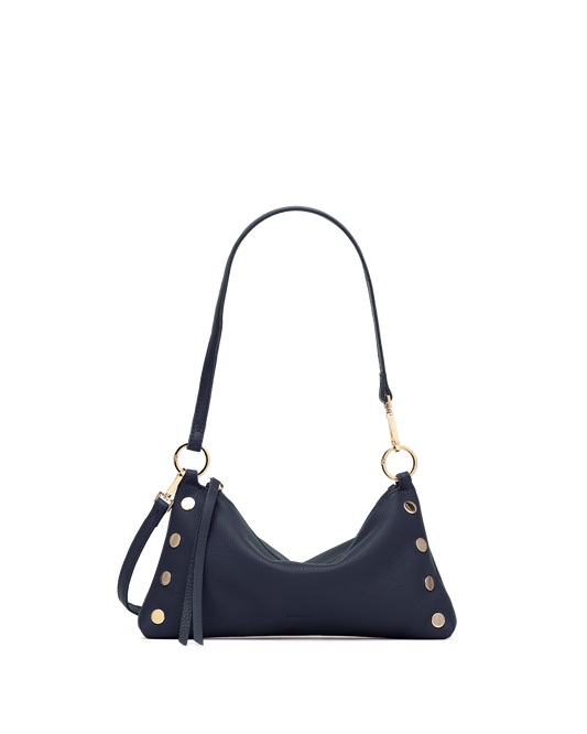 A navy blue leather shoulder bag with gold-tone hardware, featuring a crescent-shaped body, a long strap, and decorative gold studs, shown against a plain white background.