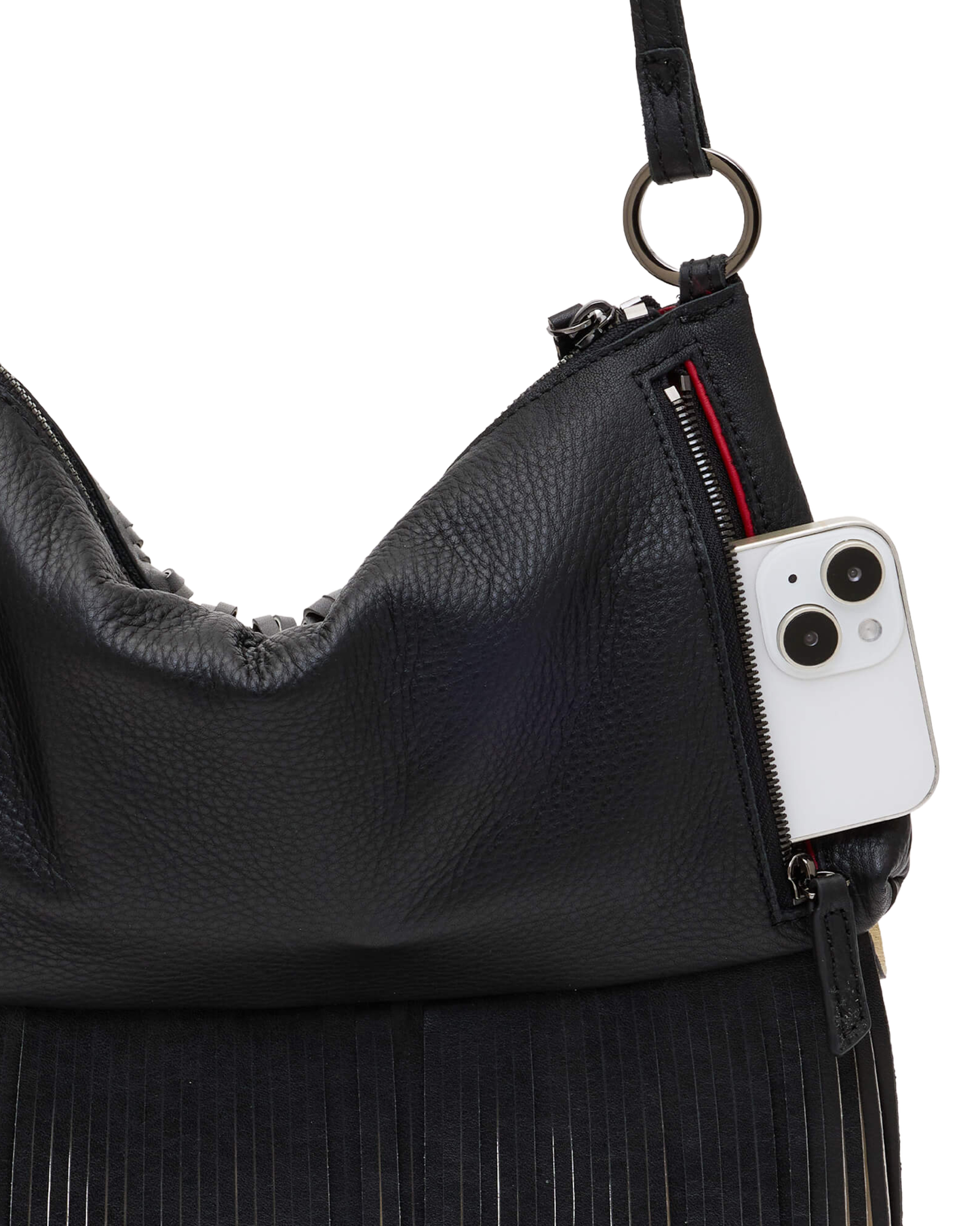 Close-up of a black pebbled leather shoulder bag with fringe detailing, showing a side zipper holding a white smartphone, on a plain white background.