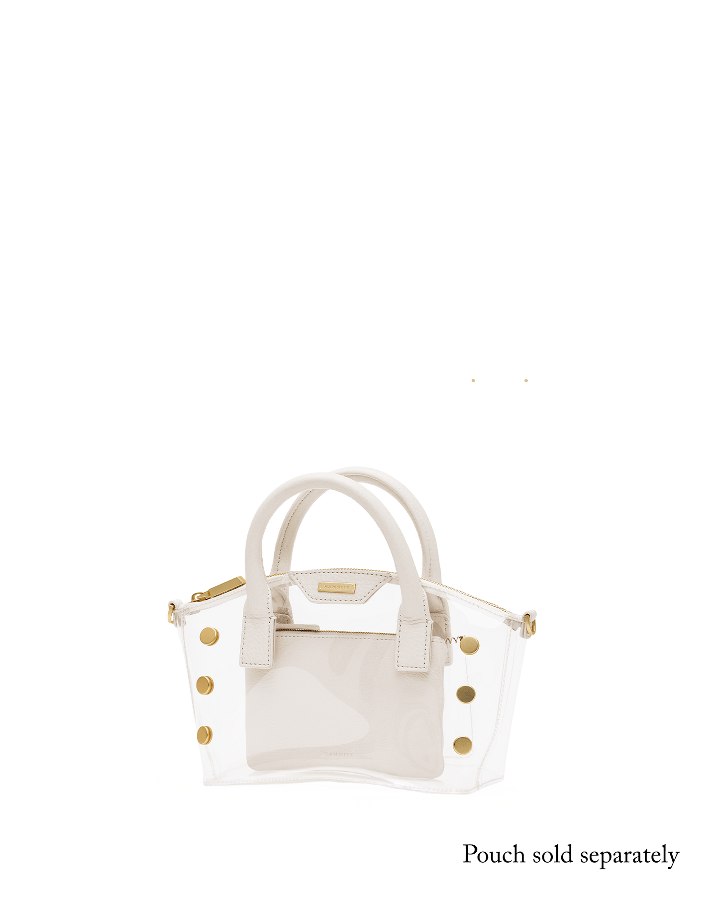 A structured handbag with a transparent clear front panel and cream-colored faux leather trim, handles, and side panels, accented with gold-tone studs and hardware.