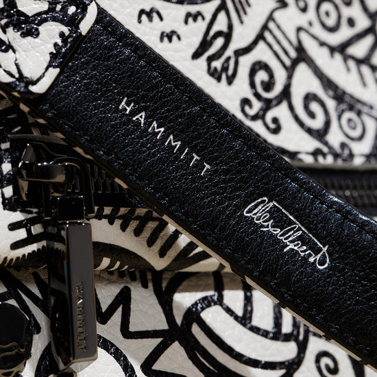 Image of close up detail image of Hammitt logo and Alex Alpert's signature on strap for Alex Alpert Collection.
