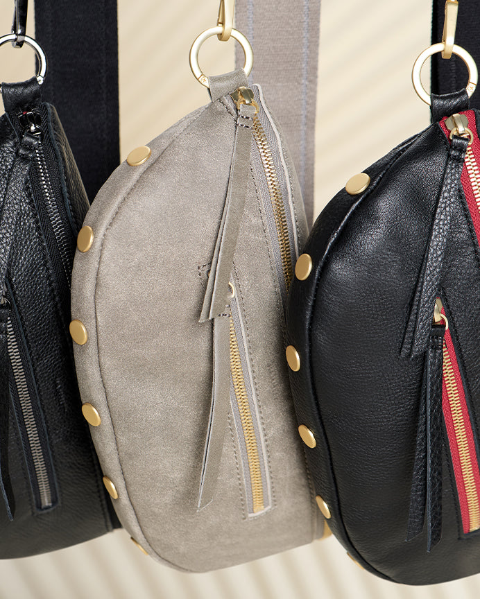 Image of three Chales meds hanging. Different styles shown black gunmetal, pewter brushed gold & black burshed gold red zip.
