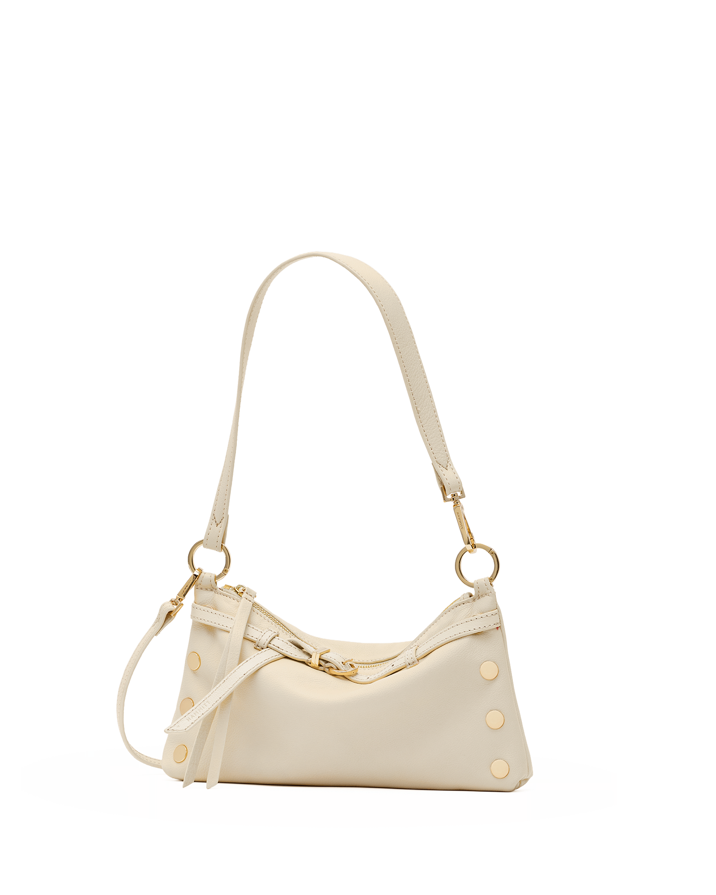 A cream-colored leather shoulder bag with gold-tone hardware, featuring a curved top, decorative rivet studs, and a long shoulder strap, shown against a plain white background.