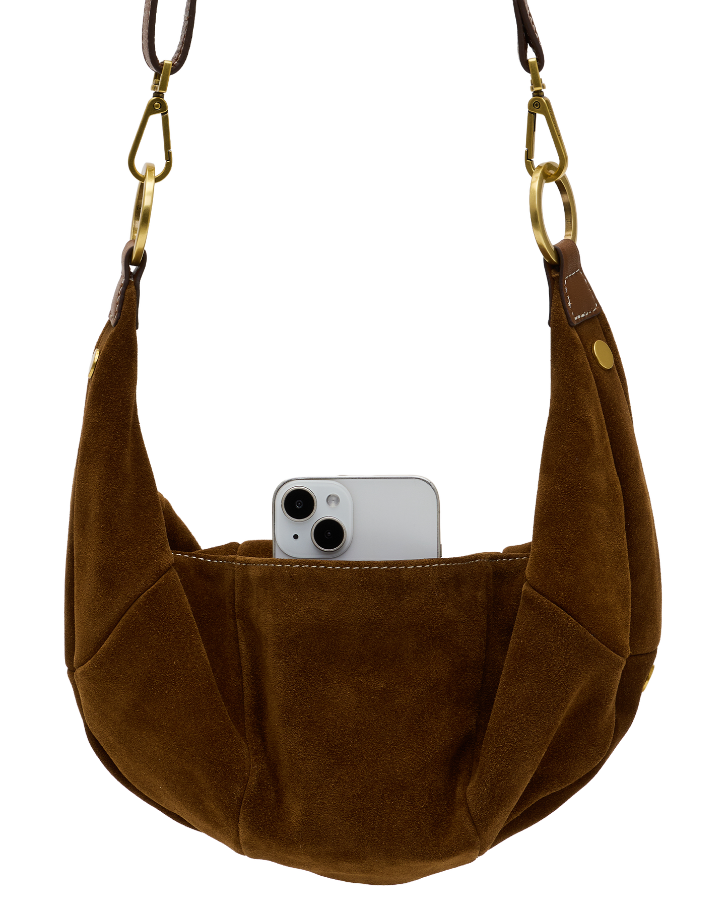 A brown suede crescent shoulder bag with gold-tone hardware and a white smartphone partially tucked into its front slip pocket, shown against a plain white background.