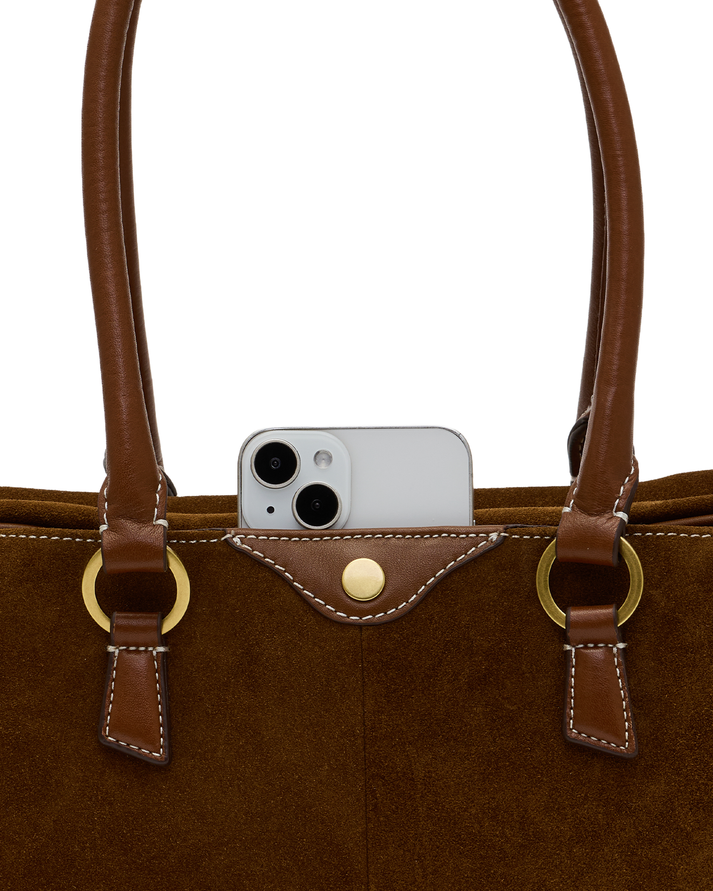 Close-up of a brown suede and leather tote bag with gold-tone hardware, shown against a white background with a silver smartphone partially tucked into the front pocket.