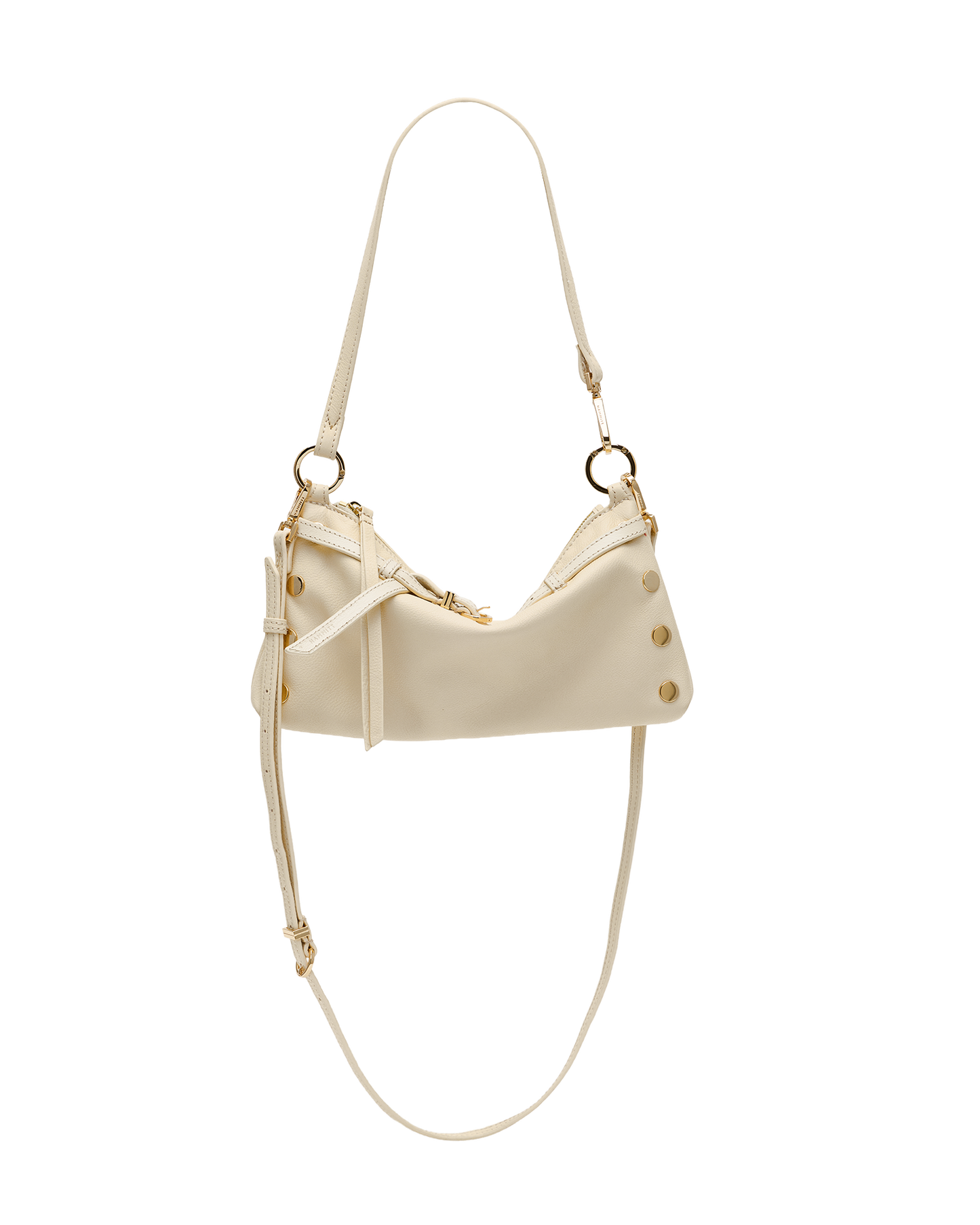 A cream-colored faux leather shoulder bag with gold-tone hardware, featuring a crescent-shaped body, decorative studs, and a long thin strap, shown against a plain white background.