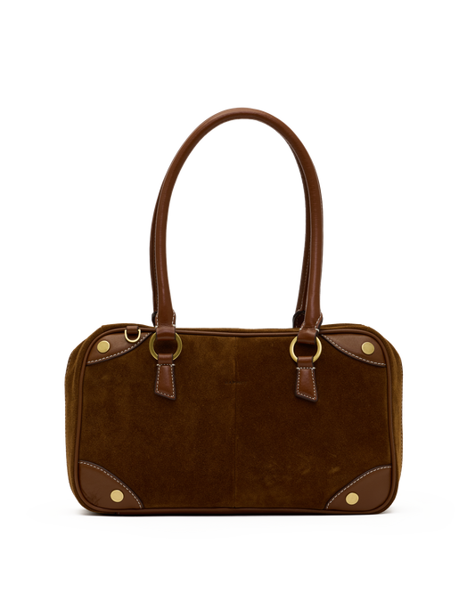A brown suede and leather handbag with gold-tone hardware, featuring dual top handles, a structured rectangular body, and decorative brass studs on a plain white background.