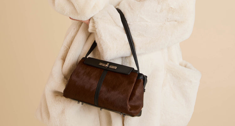 calf hair leather purse backpack Cowhide Print Diaper Rucksack Shoulder Straps combining two harness straps to form a long shoulder strap attached to metal hooks on the sides. SOHO Dark Horse Pony Hair