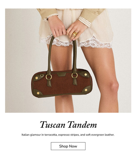 A model holds a structured brown handbag with terracotta and espresso stripes, olive green leather trim and handles, and gold-tone hardware. The image includes text below reading 'Tuscan Tandem' and a 'Shop Now' button on a white background.