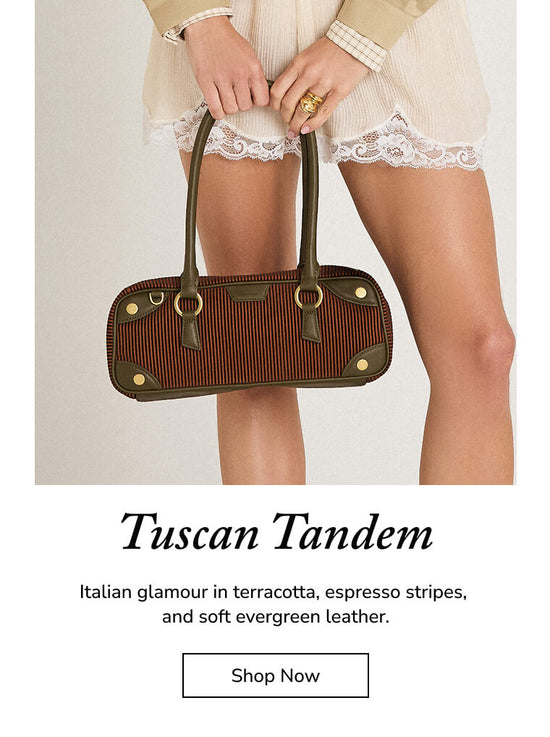 A model holds a structured handbag with a terracotta and espresso striped body, olive green leather handles and trim, and gold-tone hardware. The image includes text below reading 'Tuscan Tandem' and a 'Shop Now' button on a white background.