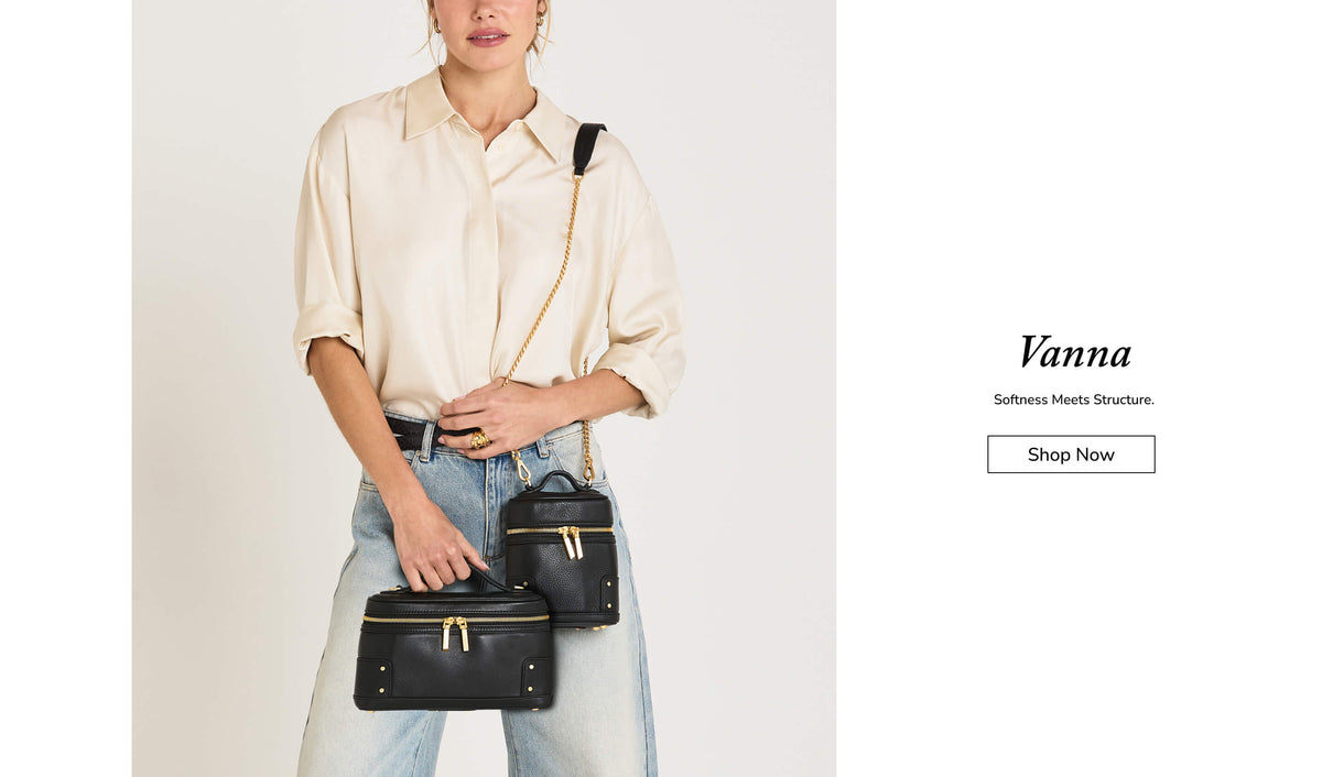 A model wearing a cream shirt and light blue jeans carries two small black crossbody bags with gold hardware, one on her shoulder and one in her hand, against a light gray background. The right side of the image features a white panel with the text 'Vanna Softness Meets Structure.
