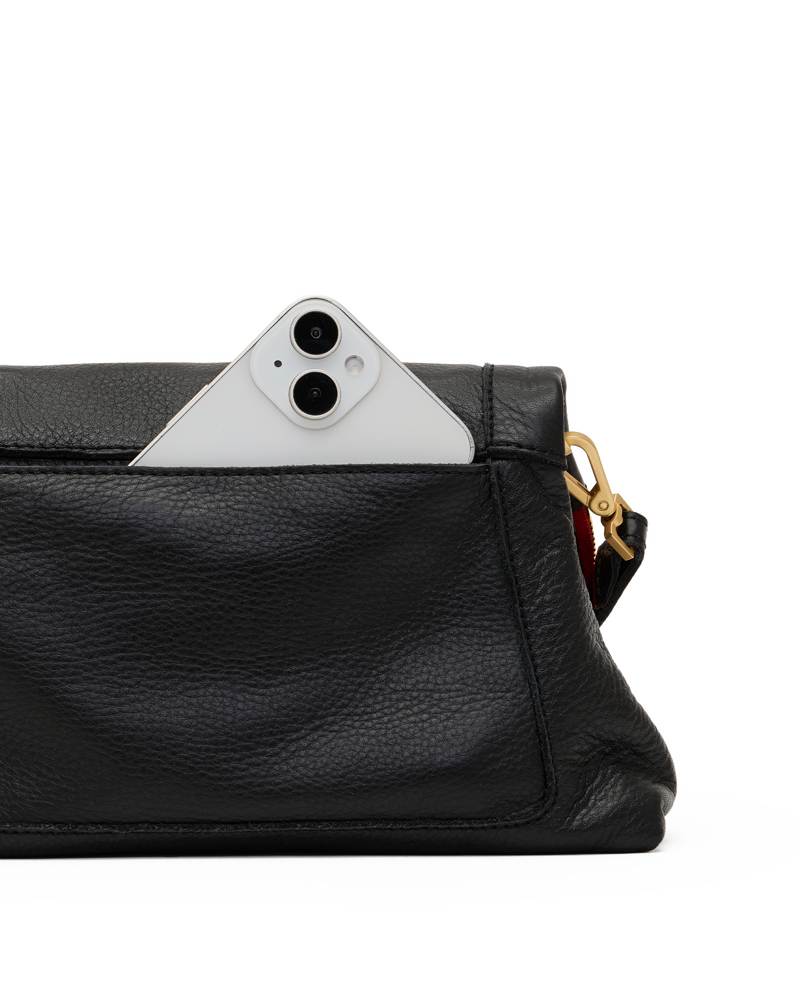 Close-up of a black pebbled leather clutch or crossbody bag with a white smartphone partially tucked into the top pocket, showing a gold-tone hardware detail and a hint of red lining on a white background.