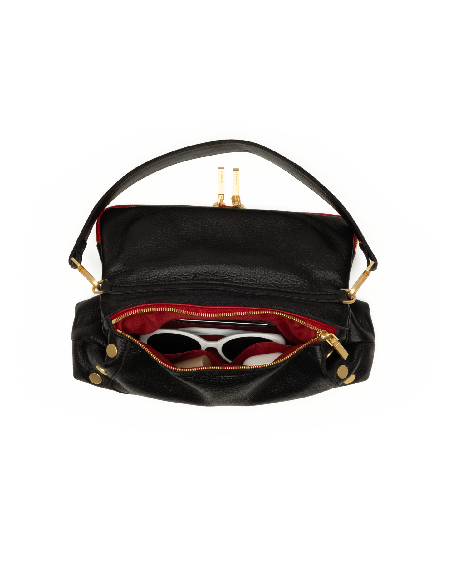 Black leather shoulder bag with gold-tone hardware, shown open to reveal a red interior lining and white-framed sunglasses inside, on a plain white background.