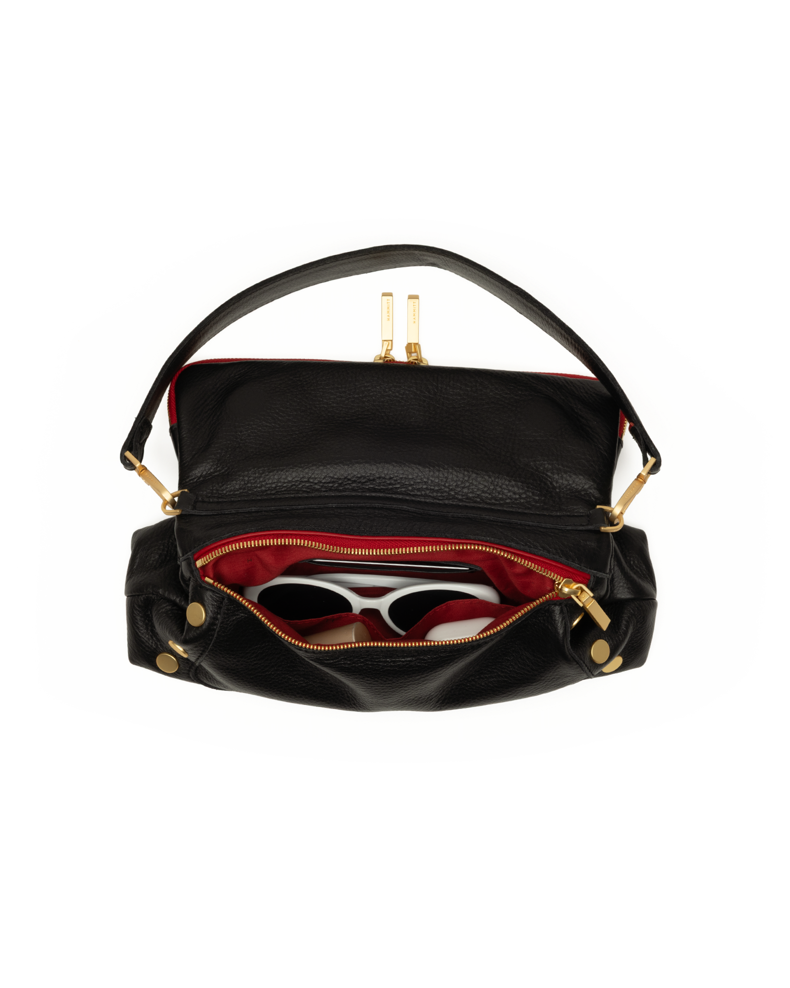 Black leather shoulder bag with gold-tone hardware, shown open to reveal a red interior lining and white-framed sunglasses inside, on a plain white background.
