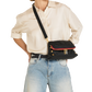 A model wearing a cream satin shirt and light blue jeans carries a black leather crossbody bag with a red leather trim and gold-tone hardware.