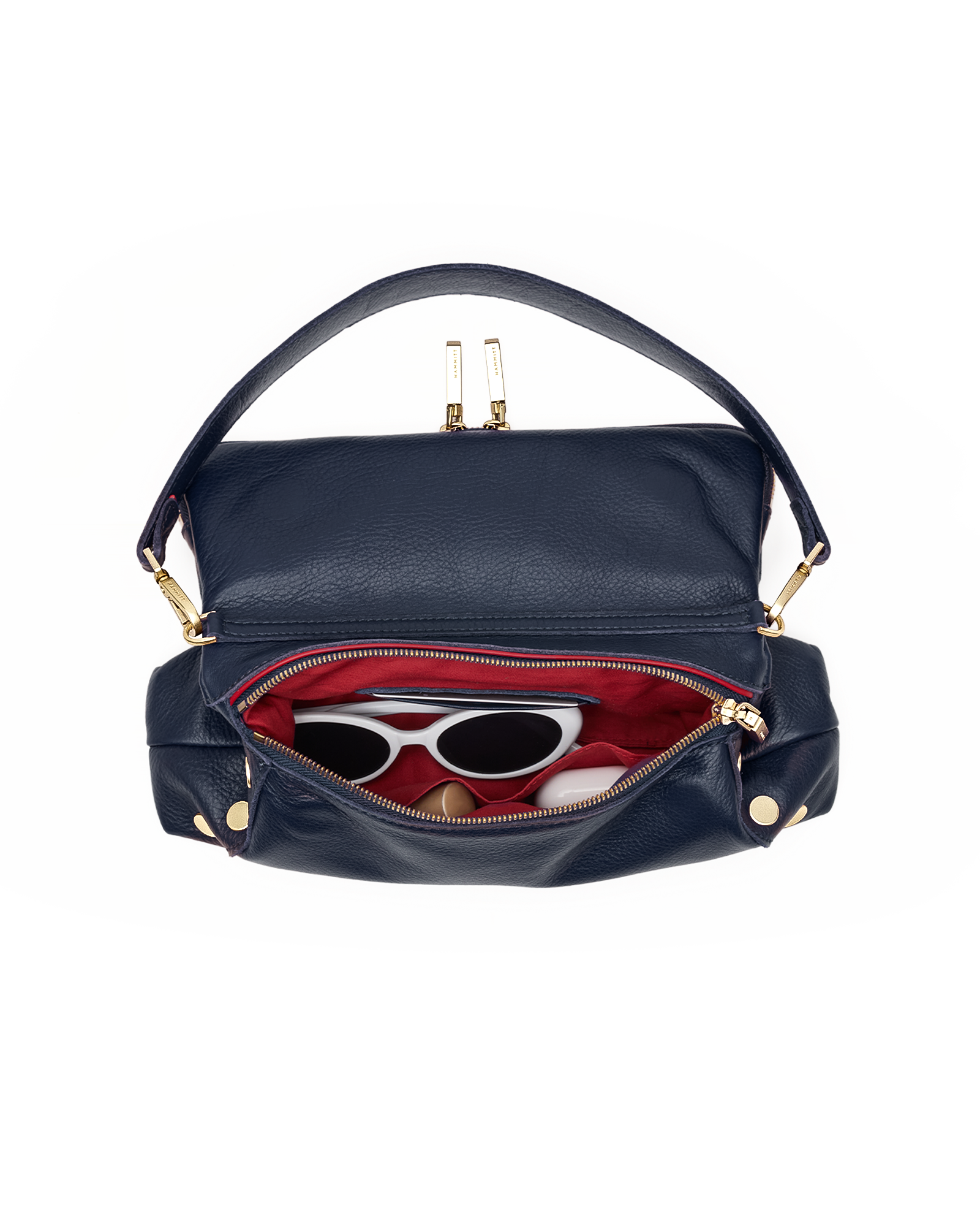 A navy blue leather shoulder bag with gold-tone hardware, shown open to reveal a red interior lining and sunglasses inside, set against a plain white background.