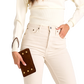 A person wearing cream ribbed knit long-sleeve top and cream high-waisted jeans, holding a brown quilted leather clutch with gold-tone studs.