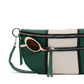 A green and cream leather crossbody bag with a geometric stripe pattern, featuring silver zippers, a green wristlet strap, and a pair of round sunglasses tucked into the front pocket.