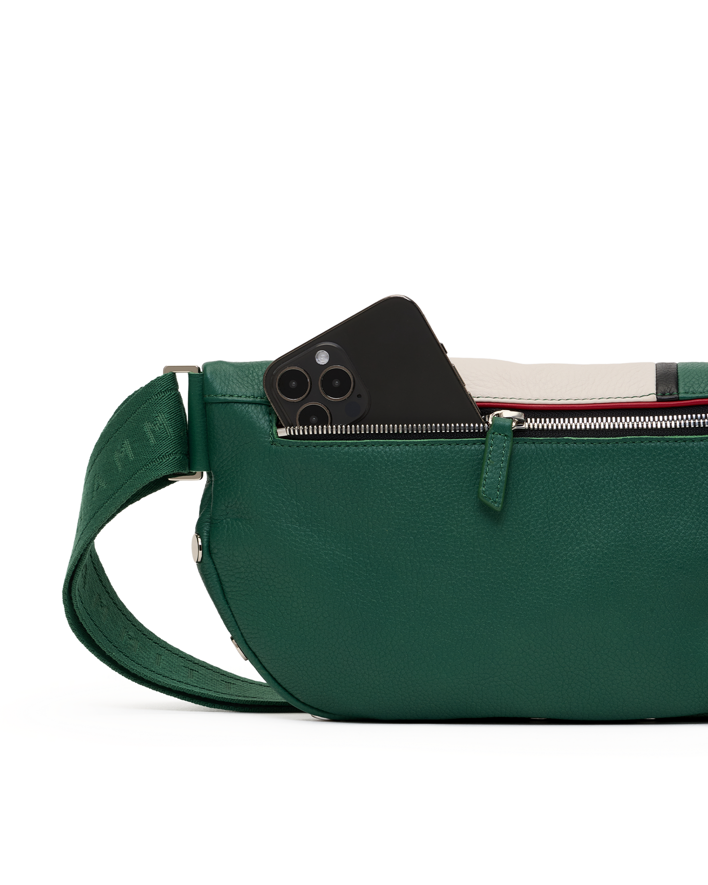 A green pebbled leather crossbody bag with a matching adjustable strap, shown in profile with a black smartphone partially tucked into the zippered pocket. The background is a clean white studio backdrop.