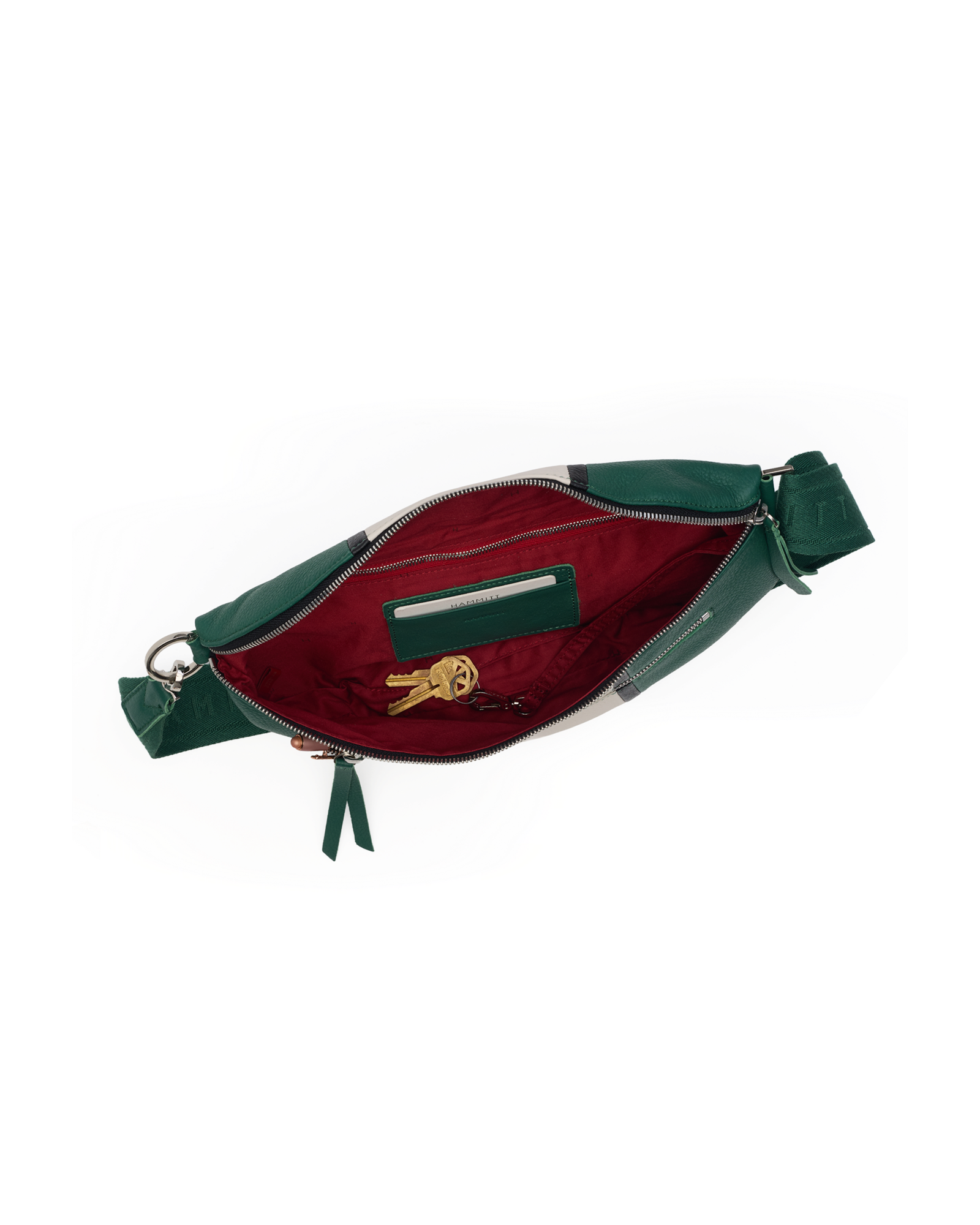A green leather waist bag shown open, revealing a deep burgundy red interior lining with a zippered pocket and a small gold keychain inside.