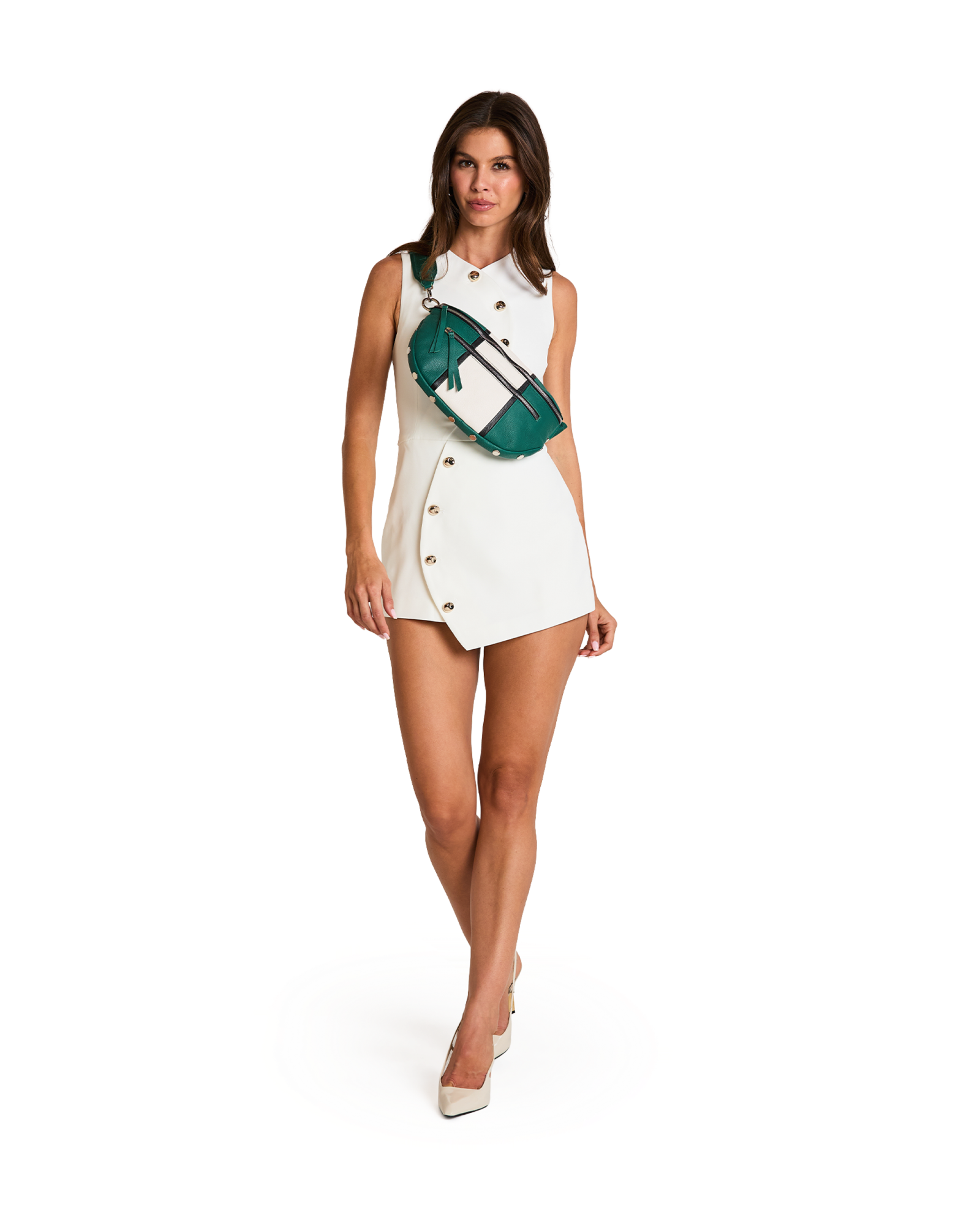 A woman modeling a white sleeveless double-breasted mini dress with gold buttons, accessorized with a green and white striped crossbody bag, on a solid white background.