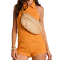 Model wearing a tan leather belt bag with gold hardware crossbody over an orange tweed romper.