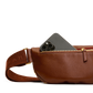 Brown leather waist bag with a phone pocket on a white background