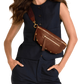 Woman wearing a brown leather waist bag on a white background
