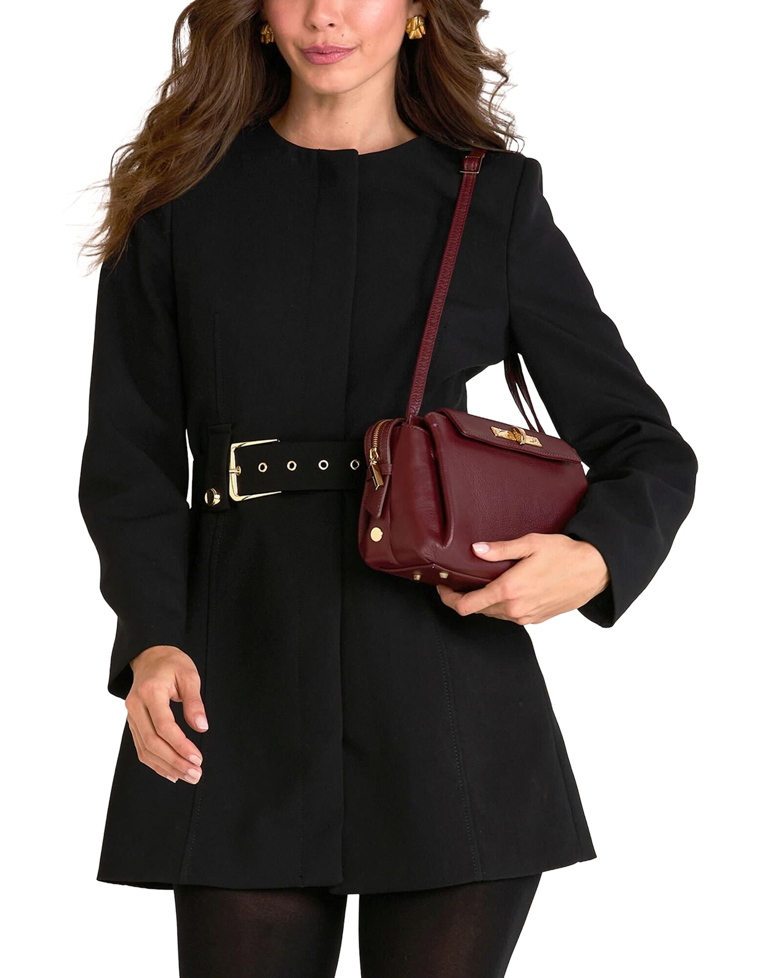 A woman wearing a black long-sleeve coat with a wide belt and holding a burgundy leather shoulder bag, shown against a plain white background.