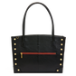 A black pebbled leather tote bag with double top handles, gold-tone rivet studs on the sides, and a horizontal red zipper pocket on the front.