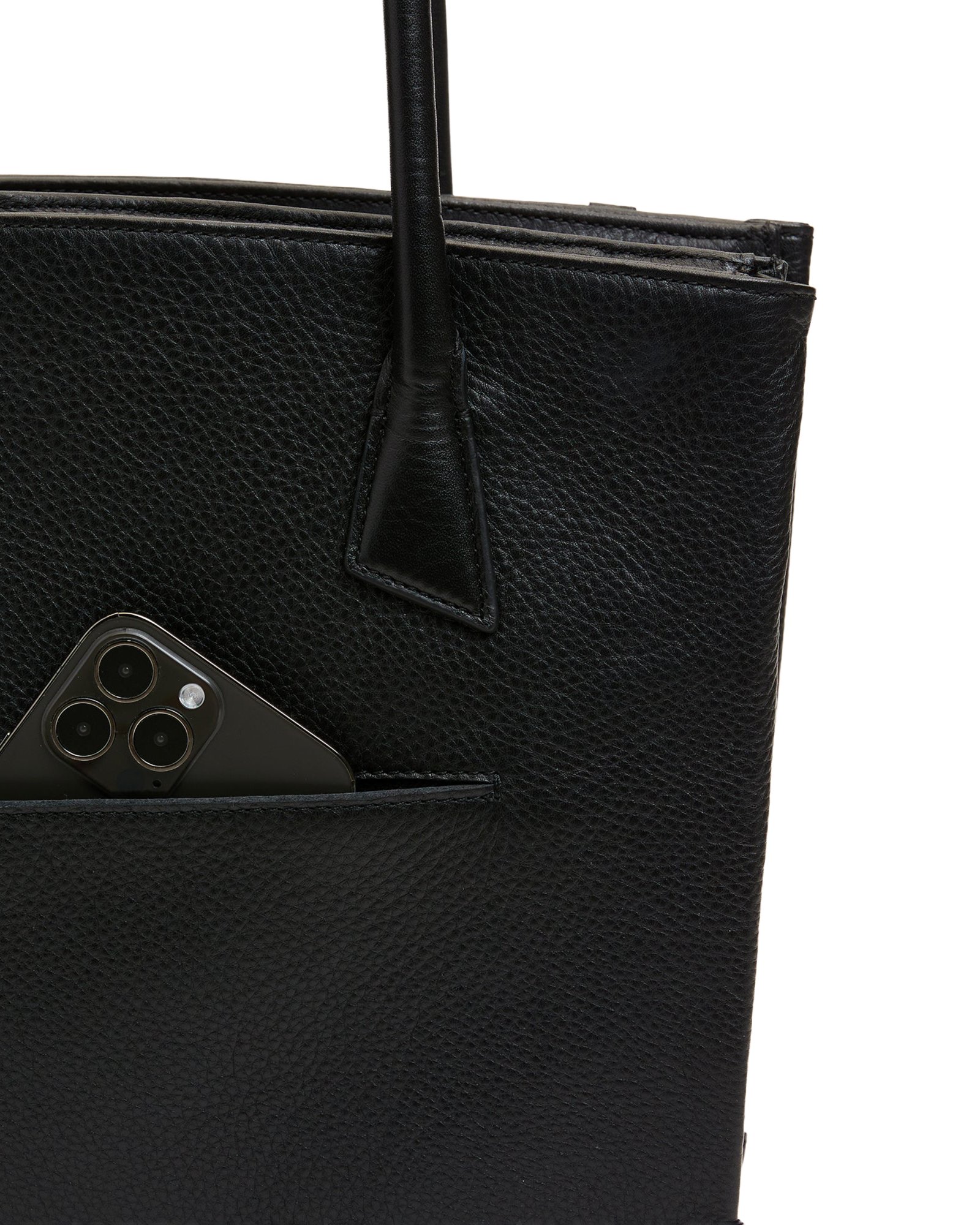 Close-up of a black pebbled leather tote bag with a side pocket holding a dark smartphone, shown against a plain white background.