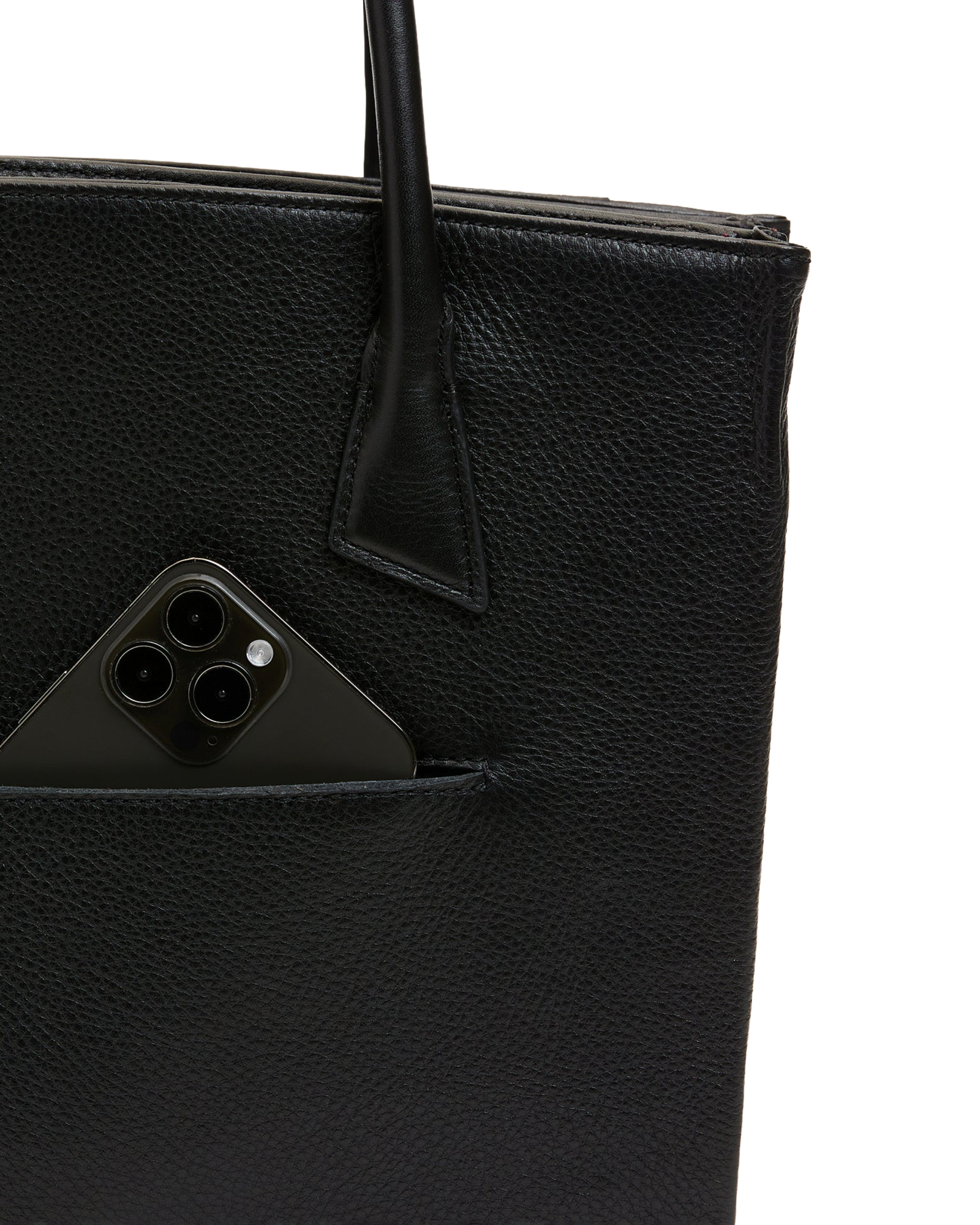 Close-up of a black pebbled leather tote bag with a side pocket holding a black smartphone, on a white background.