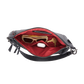 An open black leather shoulder bag with a bright red interior lining, shown against a plain white background. Inside, the bag contains sunglasses, keys, a white earbud case, and a slim black accessory.