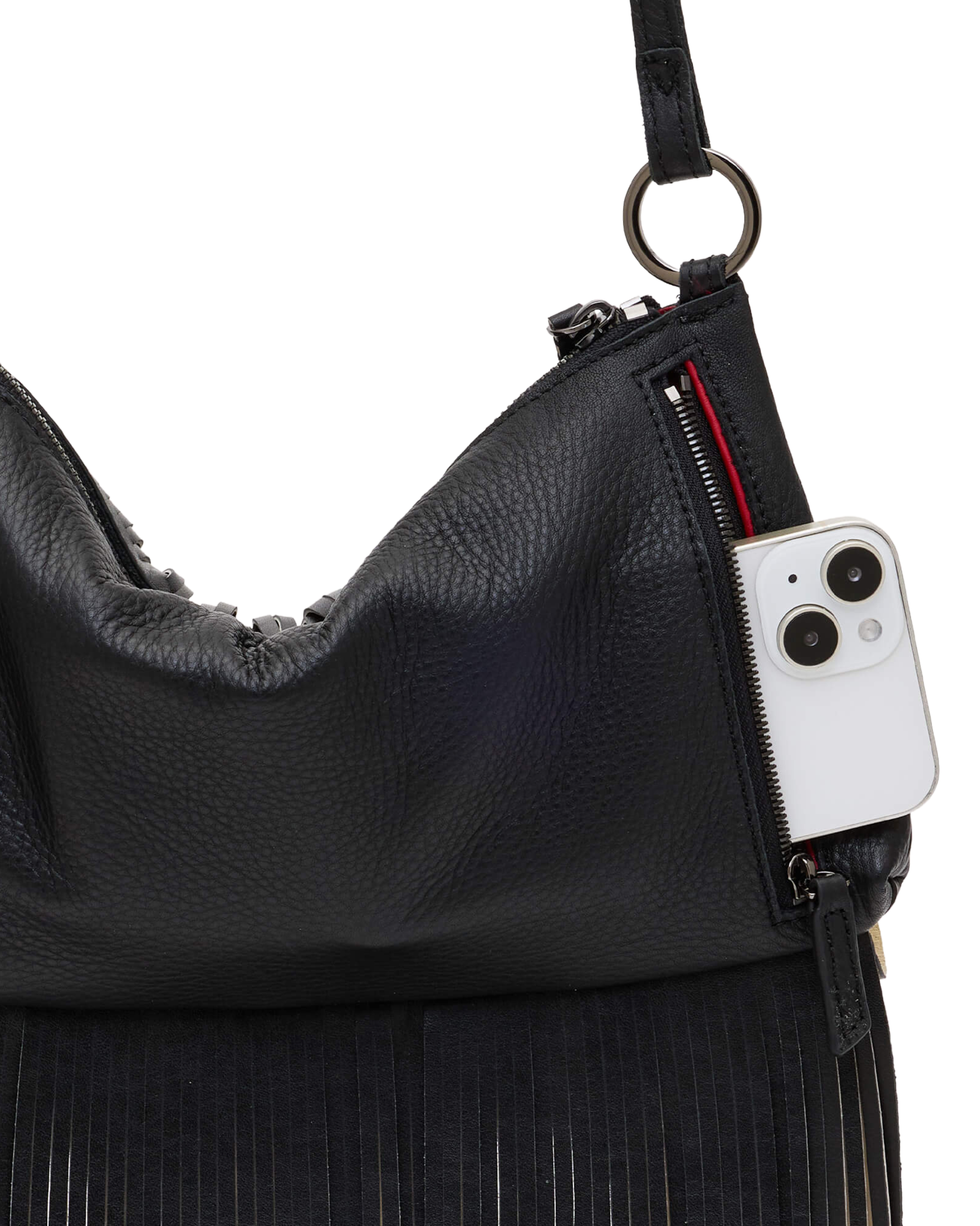 Close-up of a black pebbled leather shoulder bag with fringe detailing, showing a side zipper holding a white smartphone, on a plain white background.