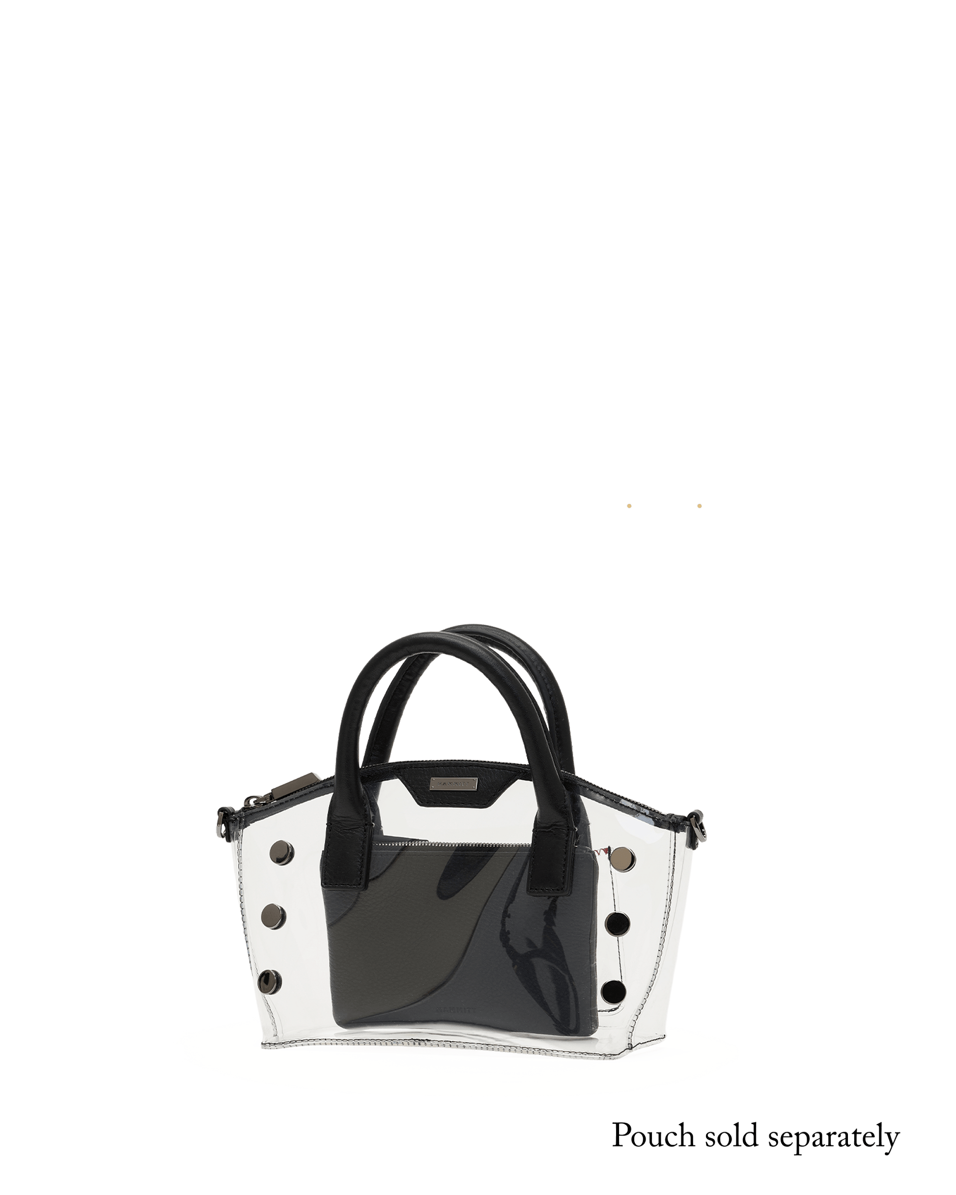A glossy black and white structured handbag with double top handles and decorative silver-tone studs, shown against a solid black background with a white circular pedestal beneath it.