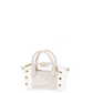 A structured handbag with a transparent clear front panel and cream-colored faux leather trim, handles, and side panels, accented with gold-tone studs and hardware.