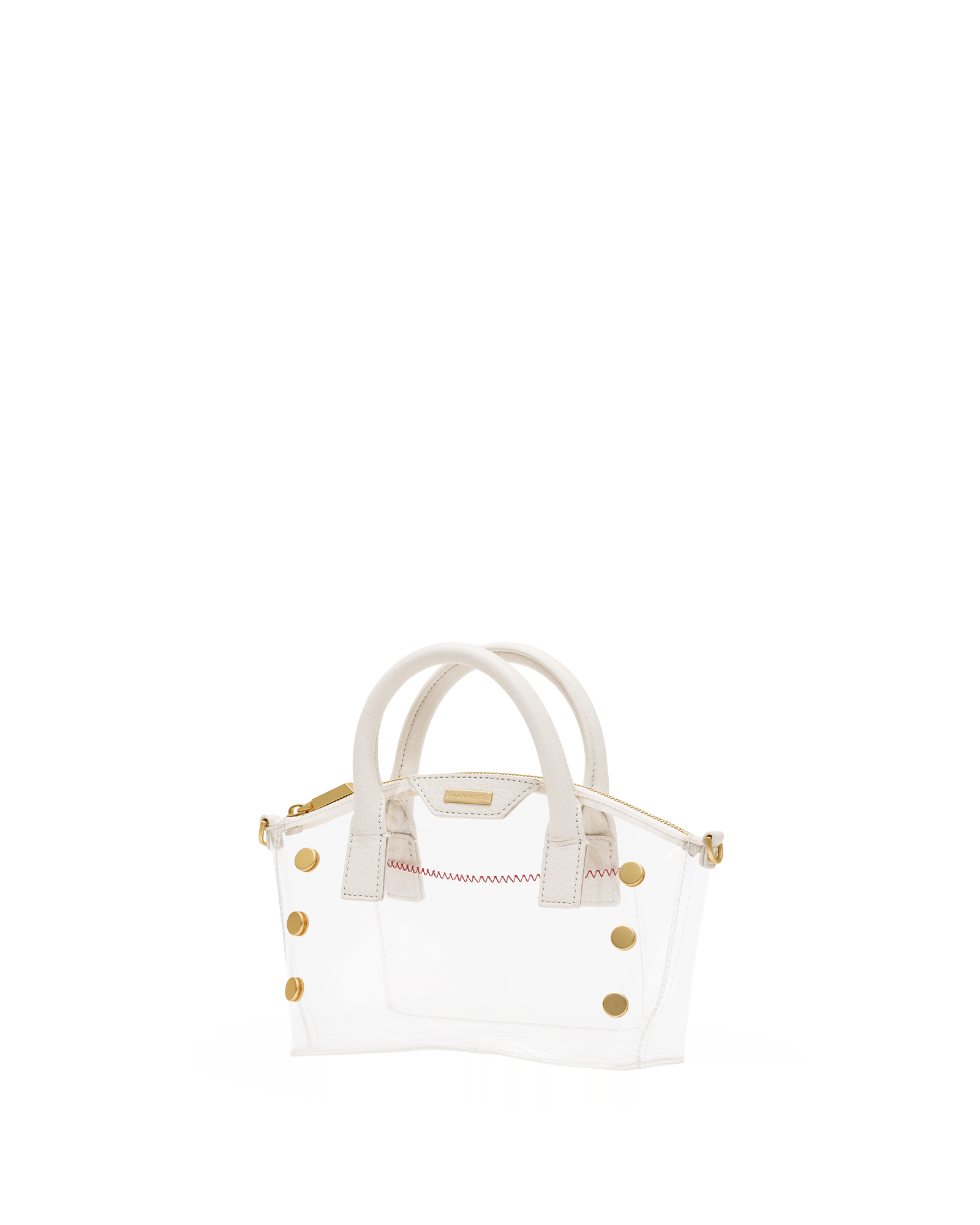 A small structured handbag with a transparent white body, cream-colored top handles, and gold-tone hardware, including decorative studs and a zipper pull.