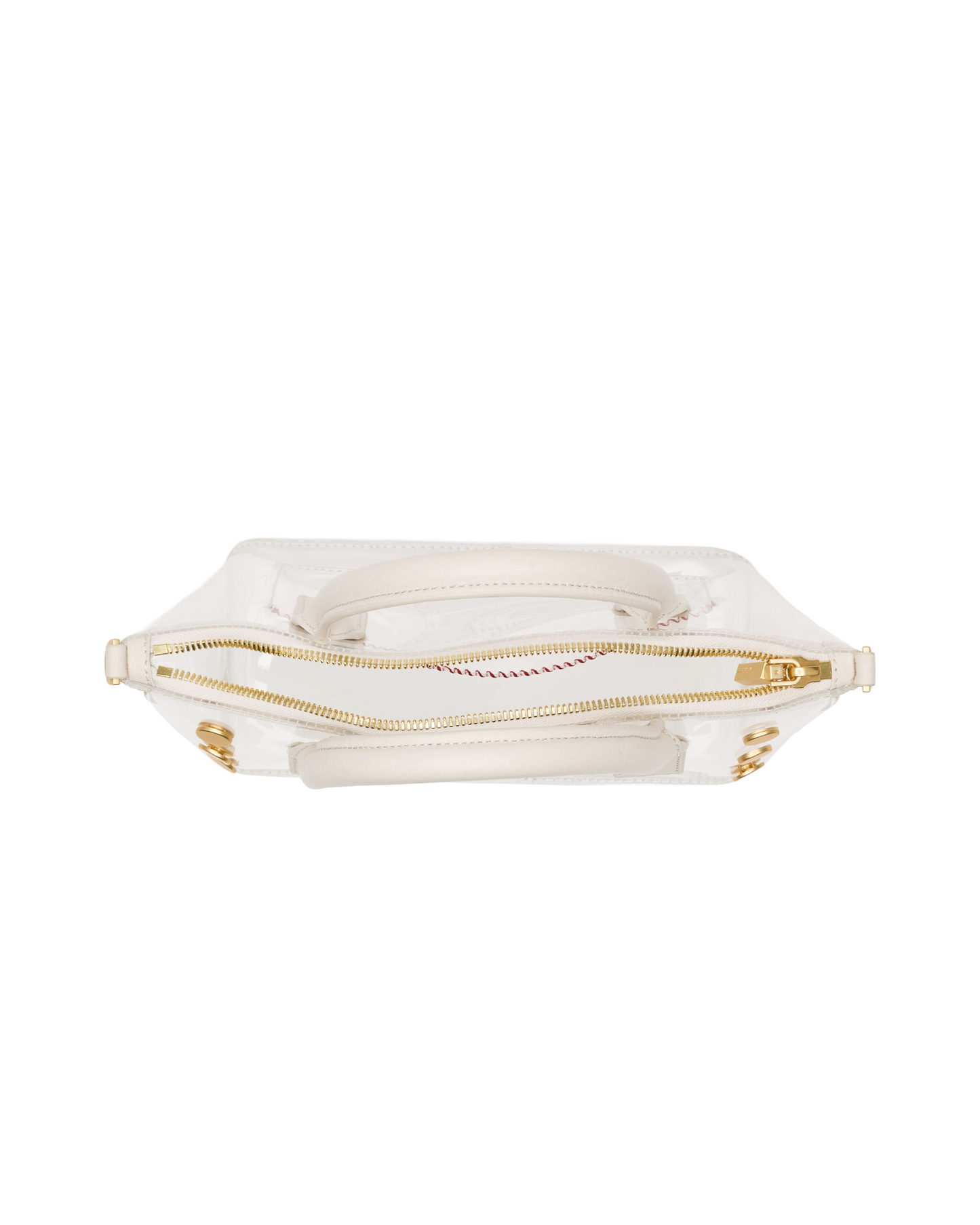 A clear vinyl handbag with a white fabric lining, gold-tone zipper, and gold hardware, shown from a top-down view on a white background.