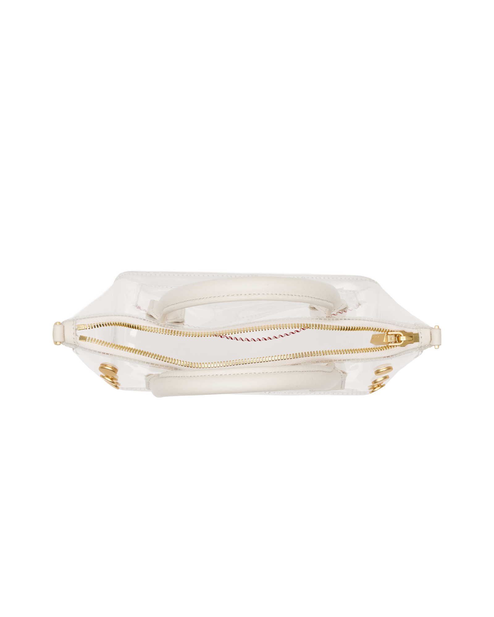 A clear vinyl handbag with a white fabric lining, gold-tone zipper, and gold hardware, shown from a top-down view on a white background.