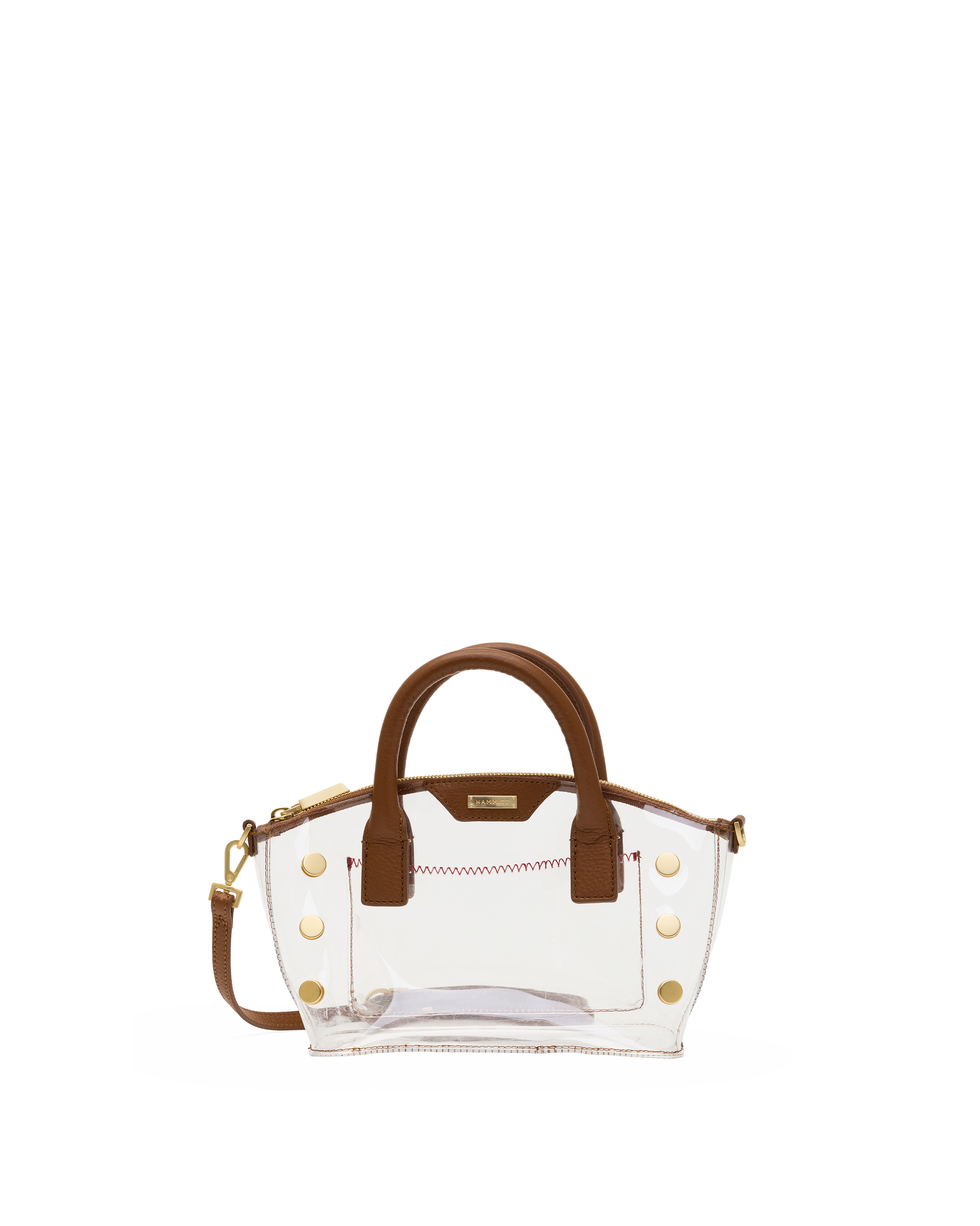 A clear vinyl handbag with brown faux-leather handles and trim, accented by gold-tone studs.