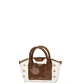 A structured handbag with a glossy brown front panel and handles, combined with a clear transparent side panel decorated with gold-tone studs.