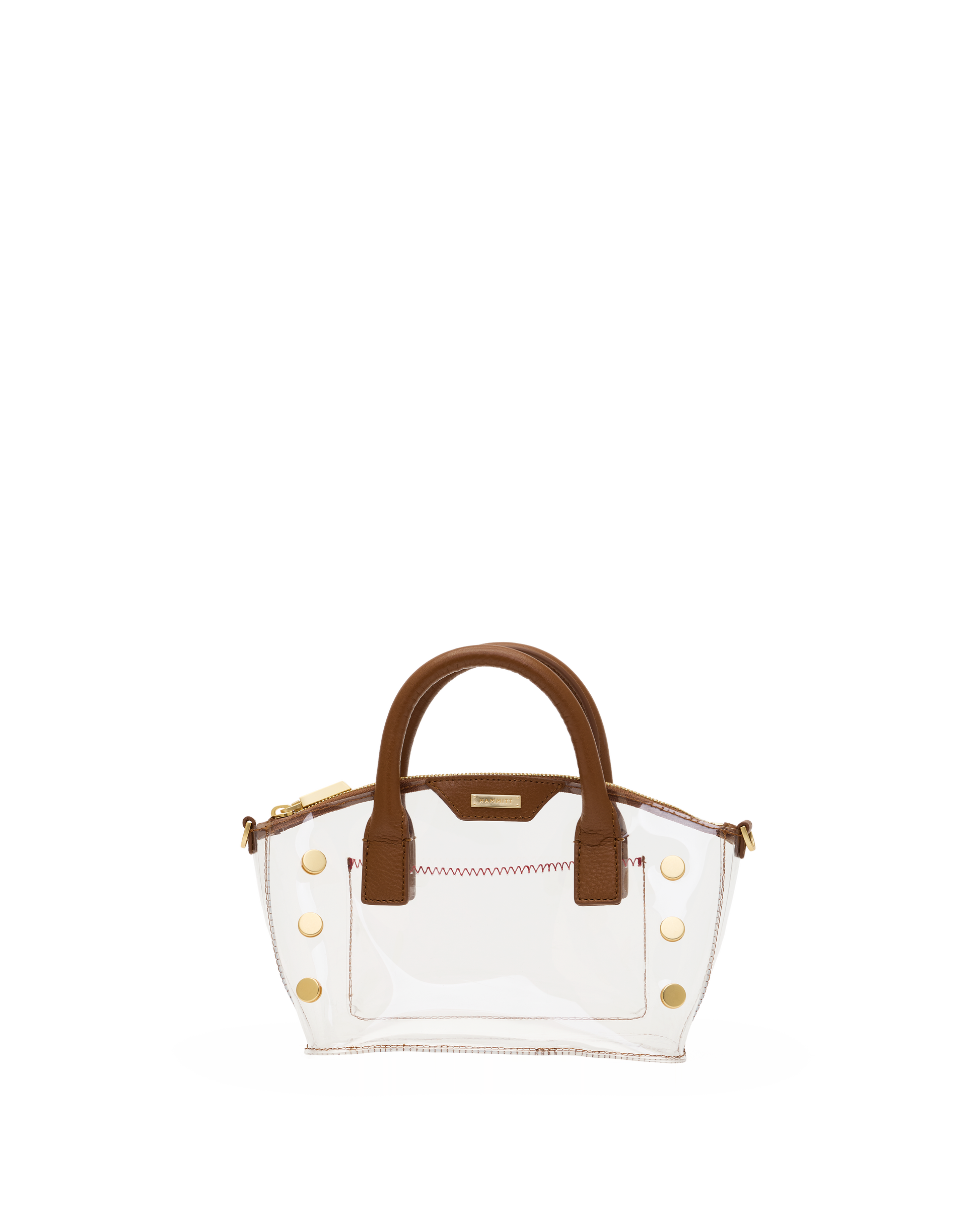 A clear vinyl handbag with brown leather handles and trim, accented by gold-tone hardware and a zippered top.