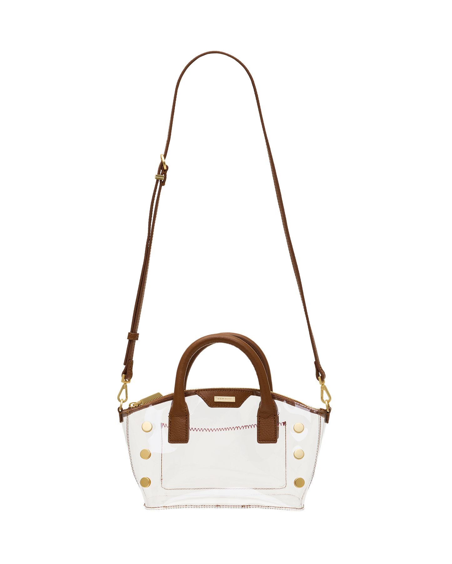 A clear acrylic handbag with brown leather handles, trim, and a shoulder strap, accented by gold-tone studs and hardware.