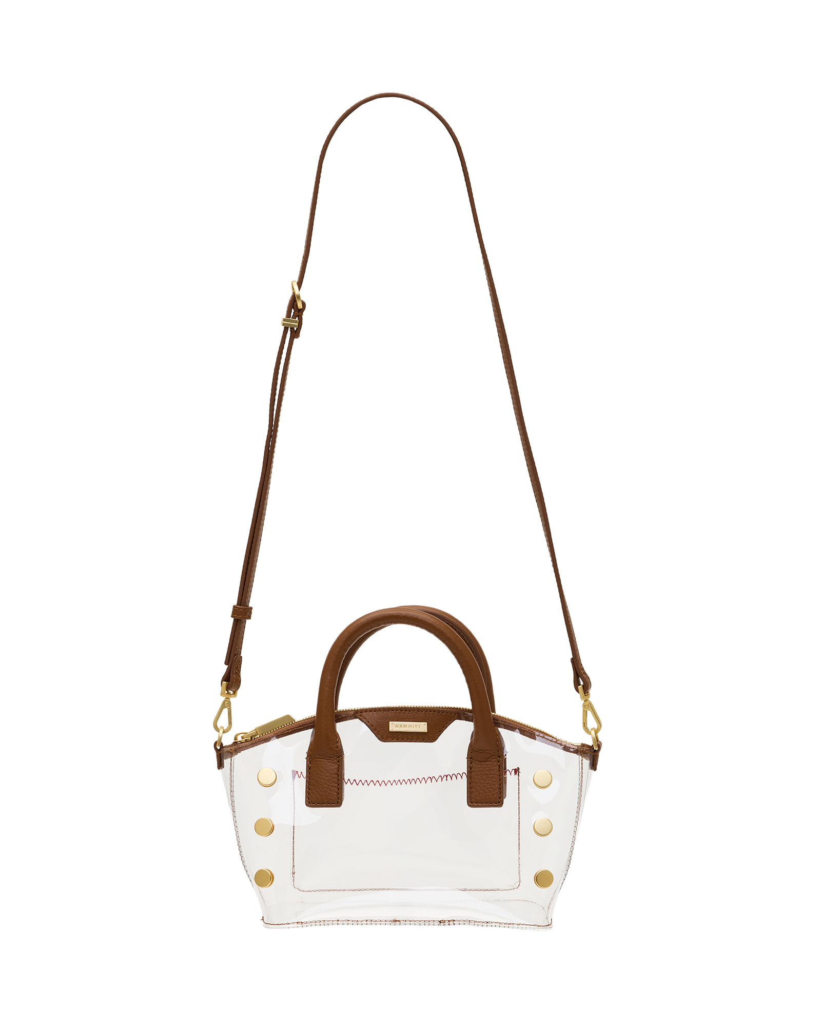 A clear acrylic handbag with brown leather handles, trim, and a shoulder strap, accented by gold-tone studs and hardware.