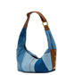 Blue denim handbag with brown leather accents on a white background