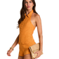 A woman modeling a sleeveless mustard yellow halter-neck romper with a button front, holding a beige clutch bag against a plain white background.