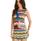 Woman wearing a colorful striped dress with a matching bag on a white background