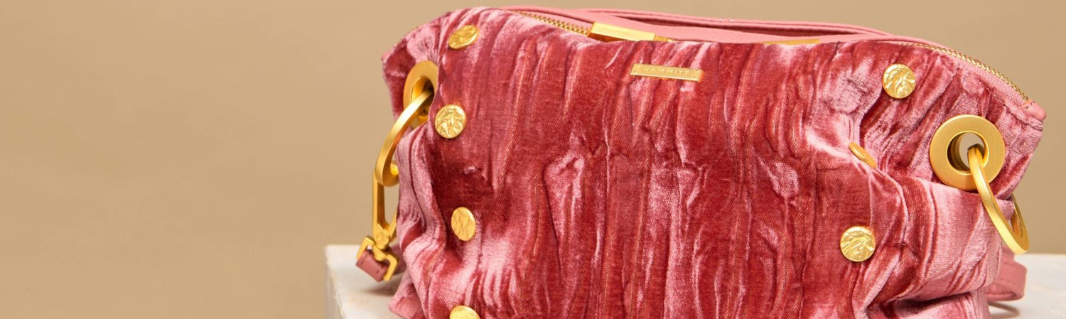Daniel Crossobyd Clutch Sml in Curtian Call Pink hammered gold on pedestal. 