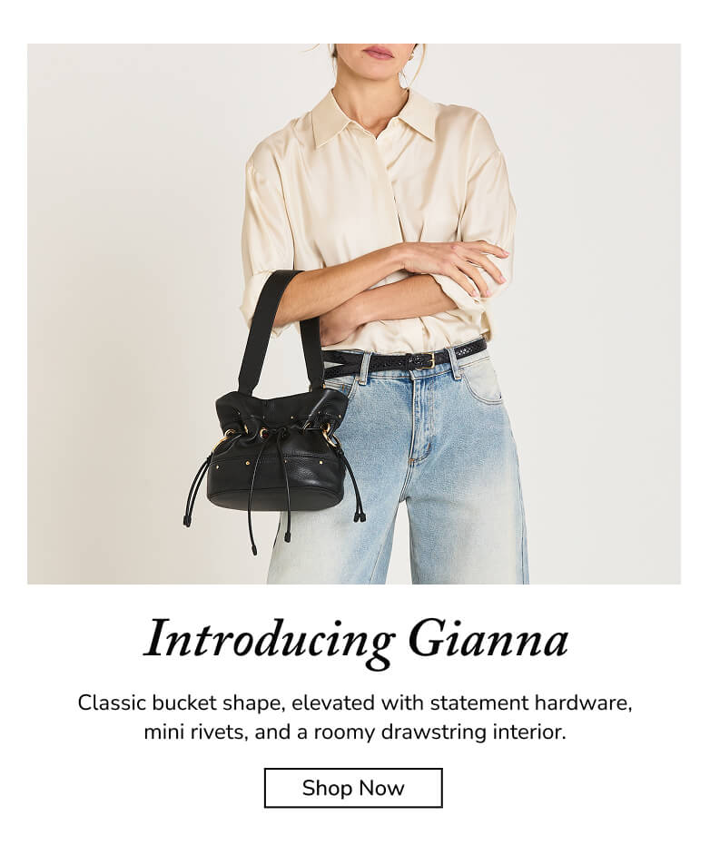 A model wears a cream button-up shirt and light blue jeans while carrying a black leather bucket bag with gold-tone hardware and a drawstring. Text below reads 'Introducing Gianna' with a 'Shop Now' button.