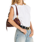 A woman wearing a white sleeveless top, light blue jeans, and a black belt with a gold buckle, carrying a dark burgundy leather shoulder bag with gold hardware.
